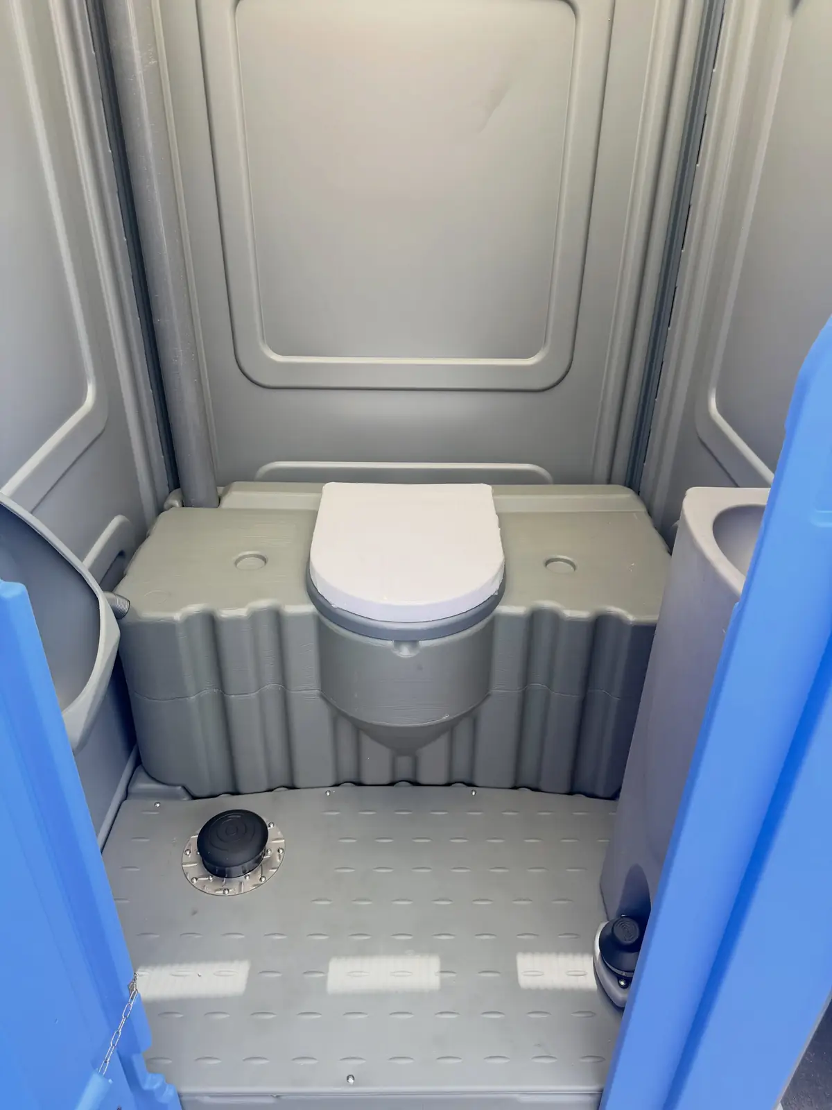 Clean gray portable toilet interior after service
